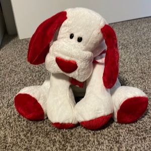 Stuffed dog with red heart collar.